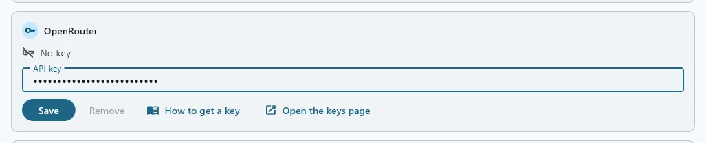 The OpenRouter card on FilmOpen’s Provider keys tab, saying No key, with a key pasted into API key and shown as dots, and Save ready to press